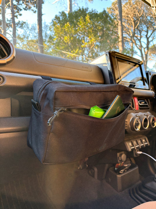 Anywhere Pouch in Black, front pouch unzipped, mounted on a Jimny 4 grab handle