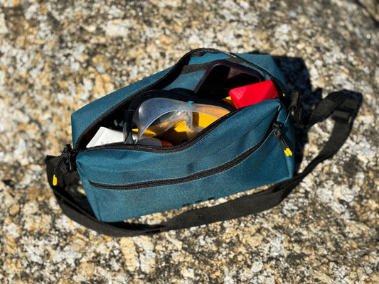 Anywhere Pouch in Teal unzipped showing the inside packed