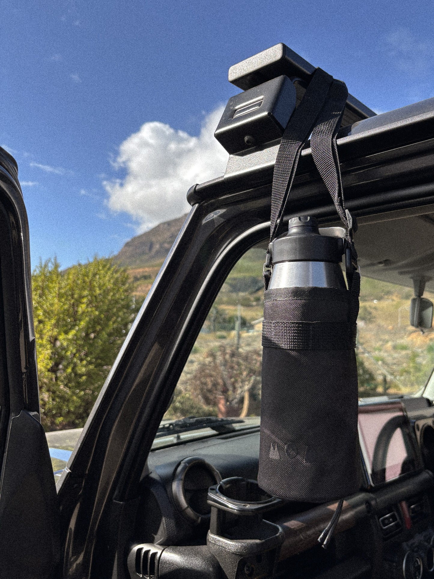 Bottle Pouch with bottle hanging from cross body sling