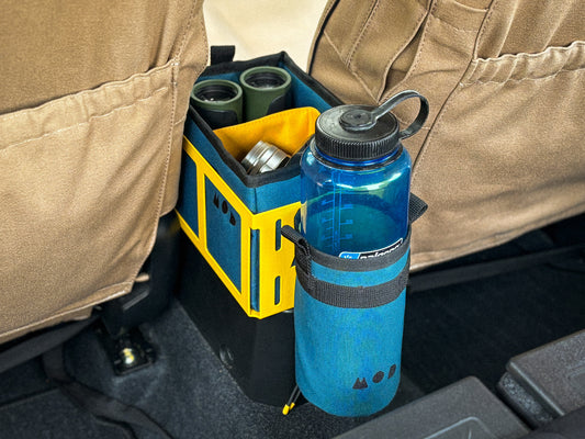 Caddy Box in Traffic Yellow with Teal Caddy Pouch packed with binoculars and camera, with Teal Water Bottle Pouch and Nalgene in Jimny