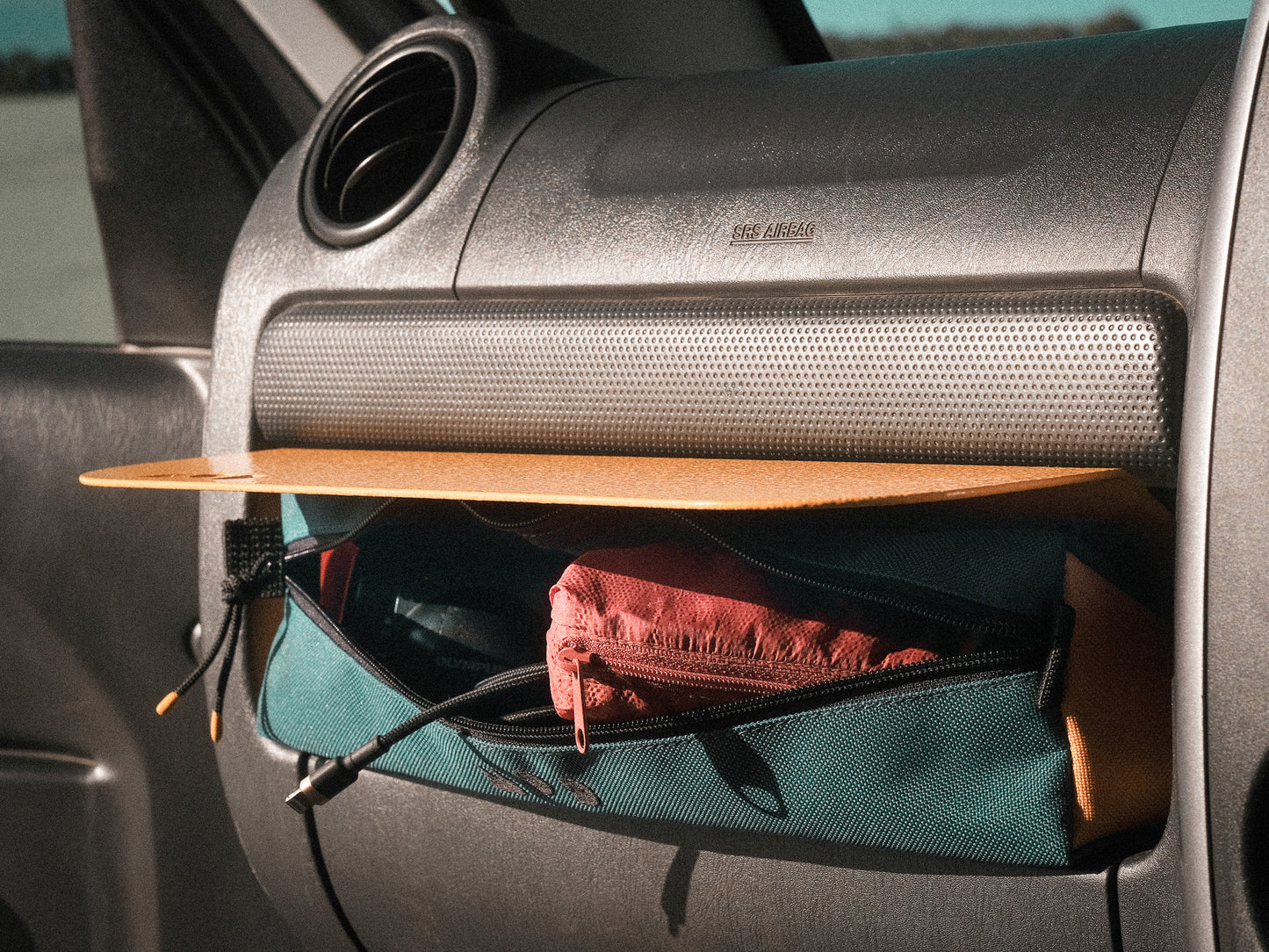 Dash Pouch in Teal/Yellow zipped open showing storage