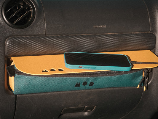 Dash Pouch in Jimny 3 in Teal/Yellow with an iPhone on the Dash Shelf