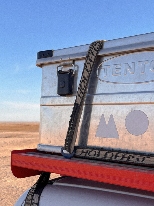 Lashing Point in Blue mounted on a Jimny 3 Roof Rack holding a box down on the roof rack