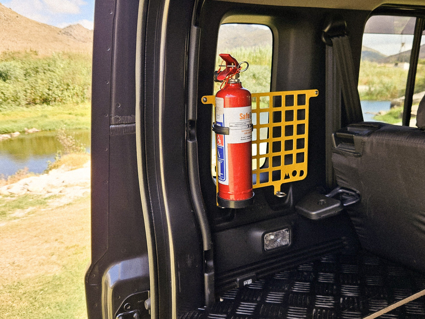 Half Molly Molle panel instlled in Jimny XL 5-door showing fire extinguisher mounted on panel