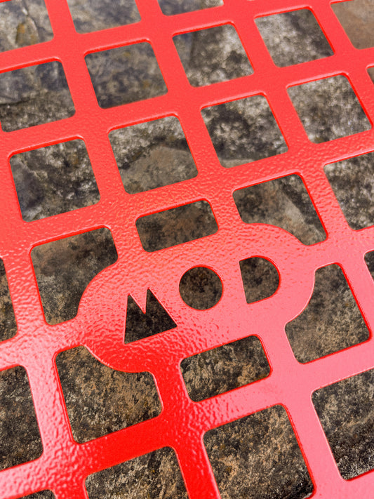 Red molle panel with a grid pattern on a textured surface