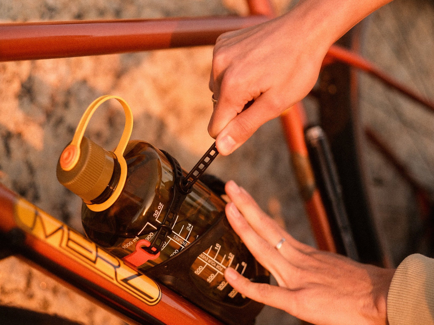 MOD StrapOnz with SoftTie strap mounted on a bicycle down tube tied with Nalgene water bottle