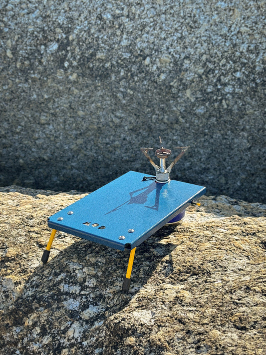 Camp Stove Table with gas canister on a rock