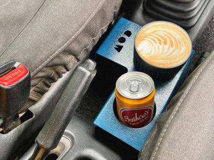 Suzuki Jimny 3 cup holder with a can and a coffee cup.