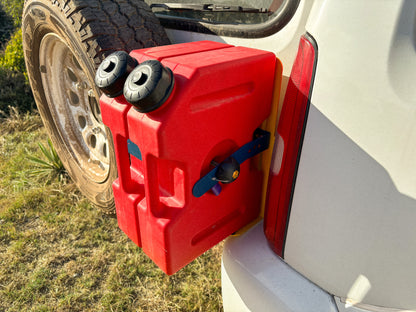 Red jerry cans on fuel tank holder on Suzuki Jimny 3 rear door showing extra fuel carrying capacity