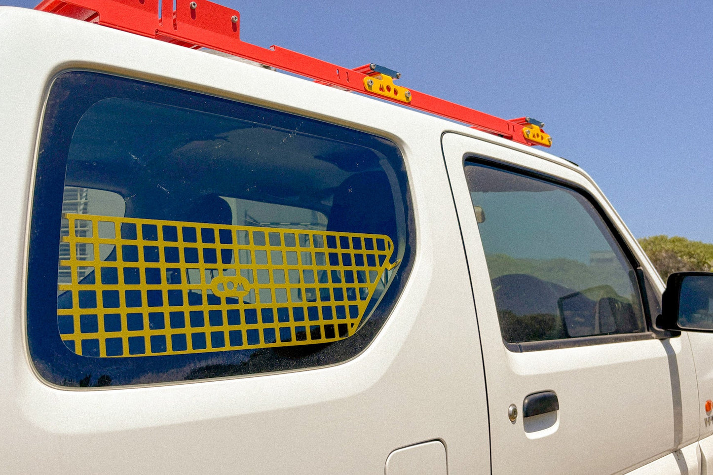 Jimny 3 with rear window molle installed showing from the outside