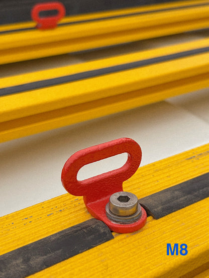 Close-up of a red MOD Lashing Point with an M8 thread, mounted on a yellow Roof Rack