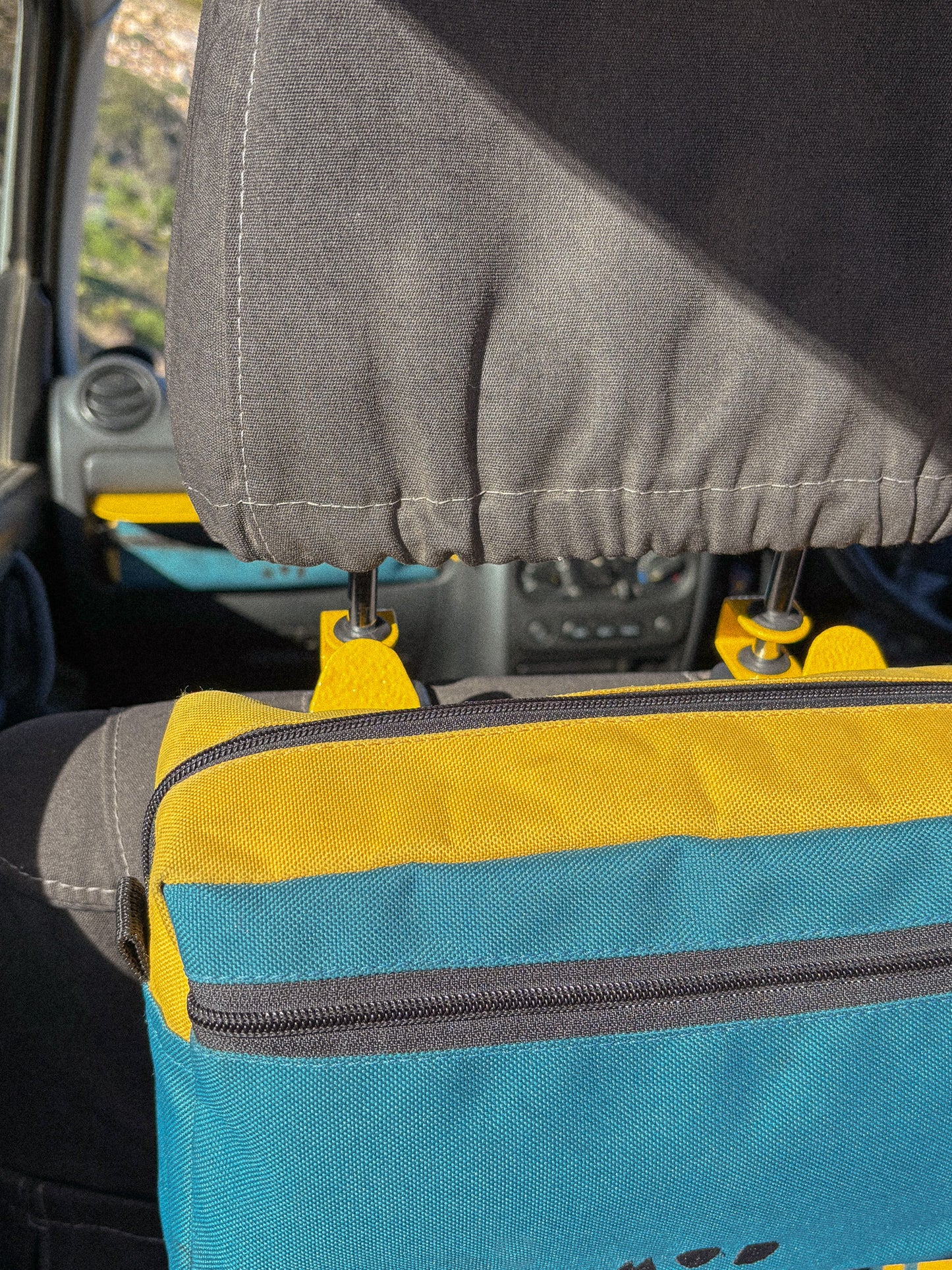 Seat Hooks on headrest posts showing storage close up with bag