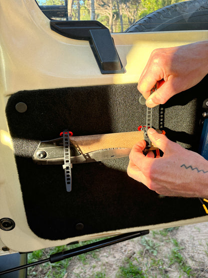 StrapOnz micro-cage cargo carrier in Red on Jimny 4 Rear Door Table Utility Panel with a saw